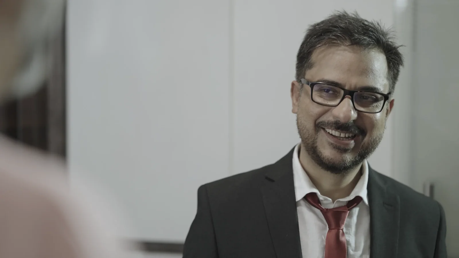 Simir smiles in conversation