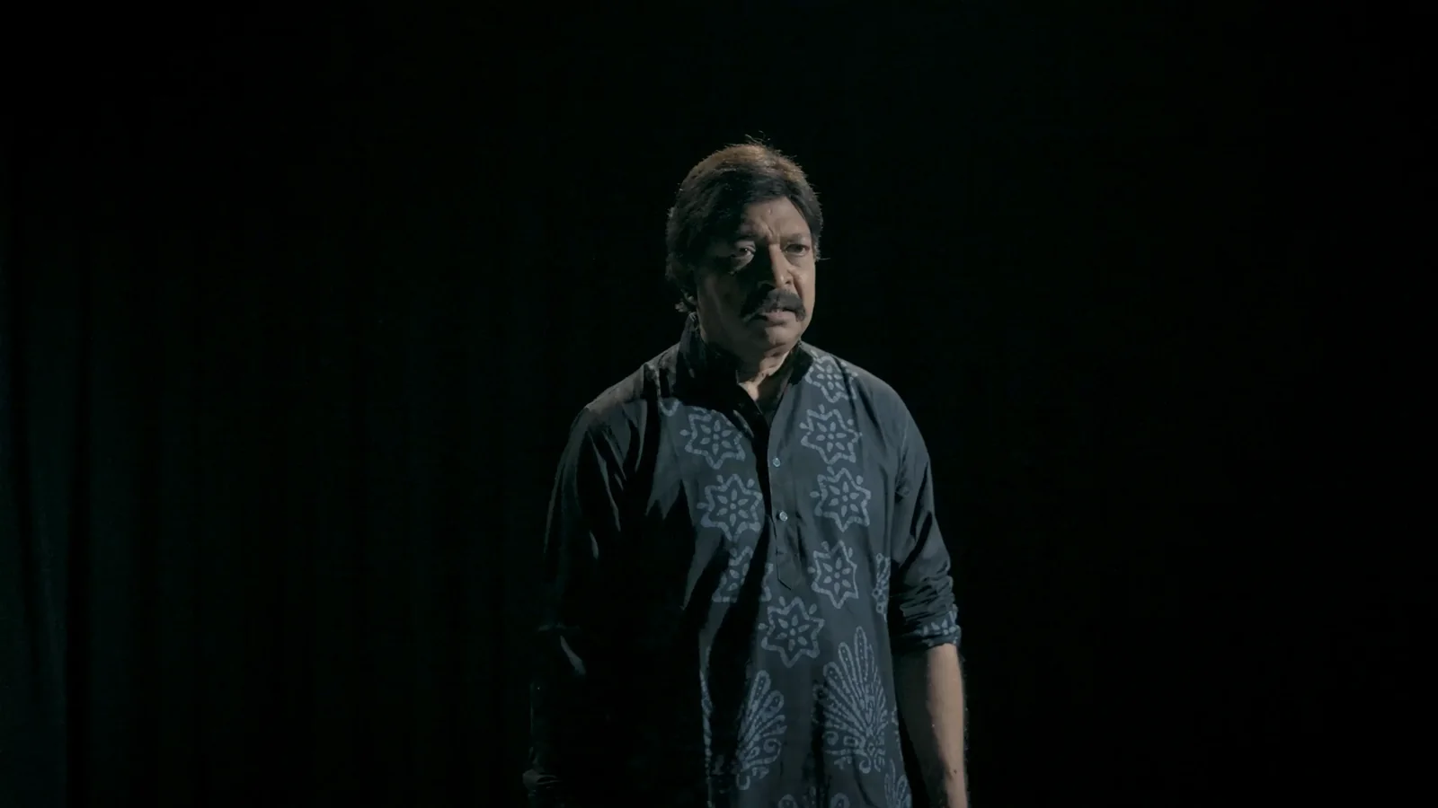 Yash Kirti alone on a dark stage