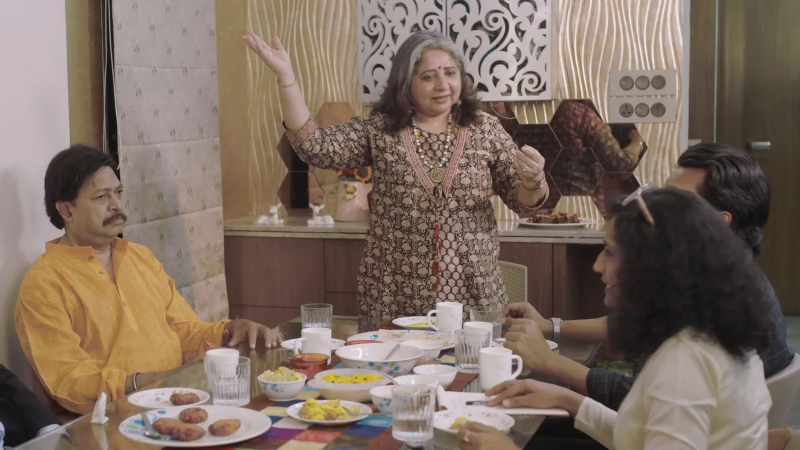 Bhavya Sangwan speaking at a dining table