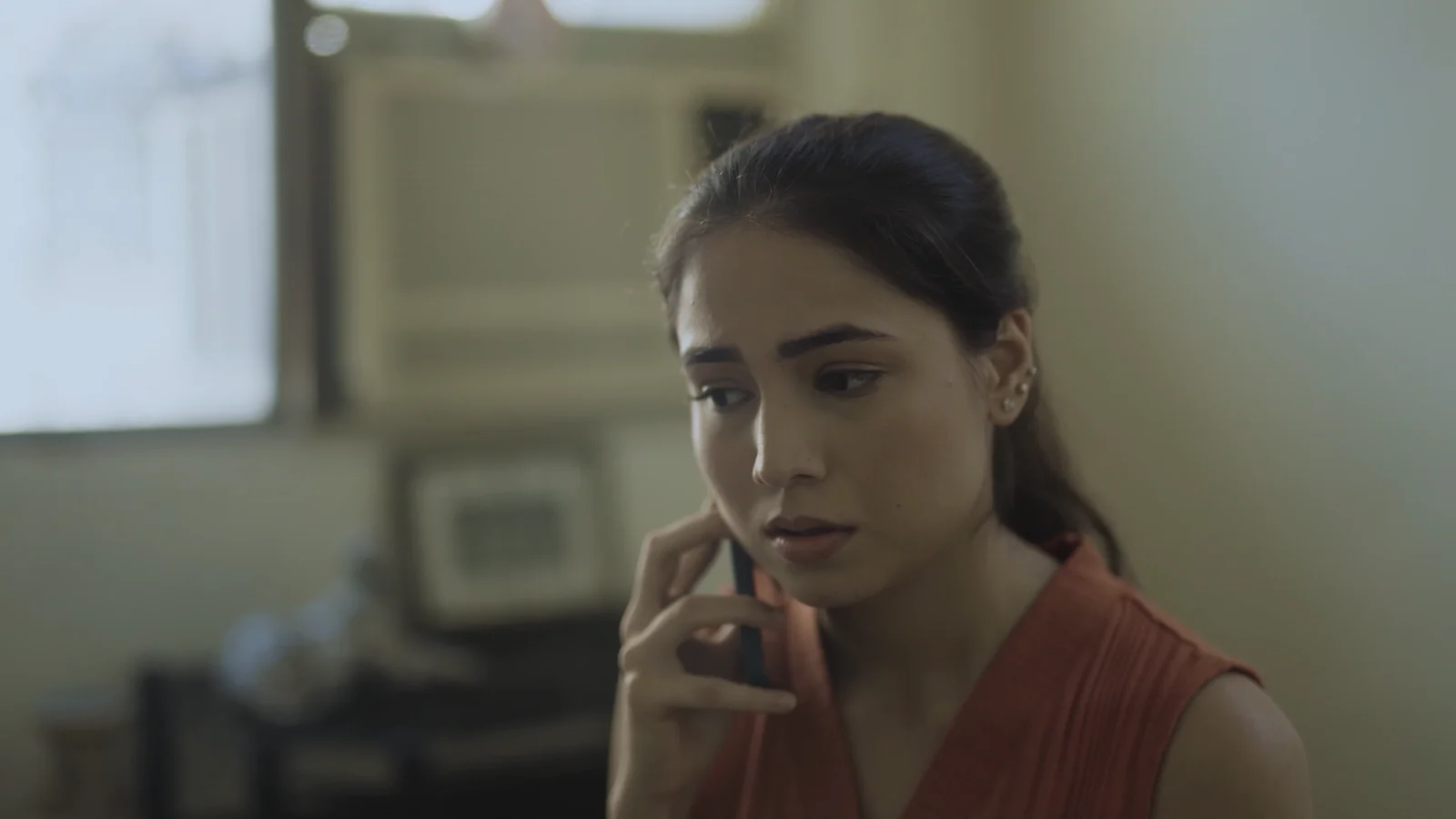 Preeti, worried, on a phone call